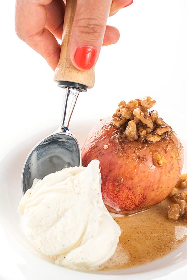 baked apple with walnut topping and with a scoop of ice cream