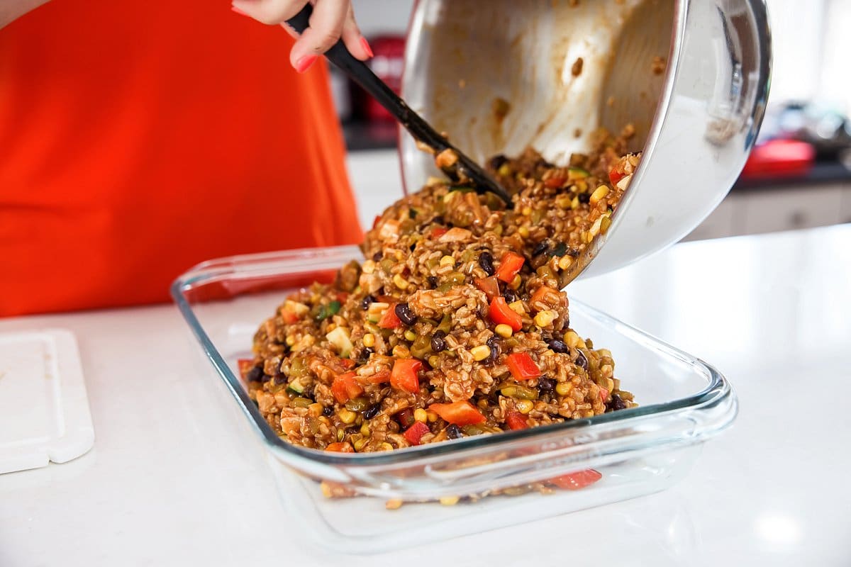 adding food mixture into pan