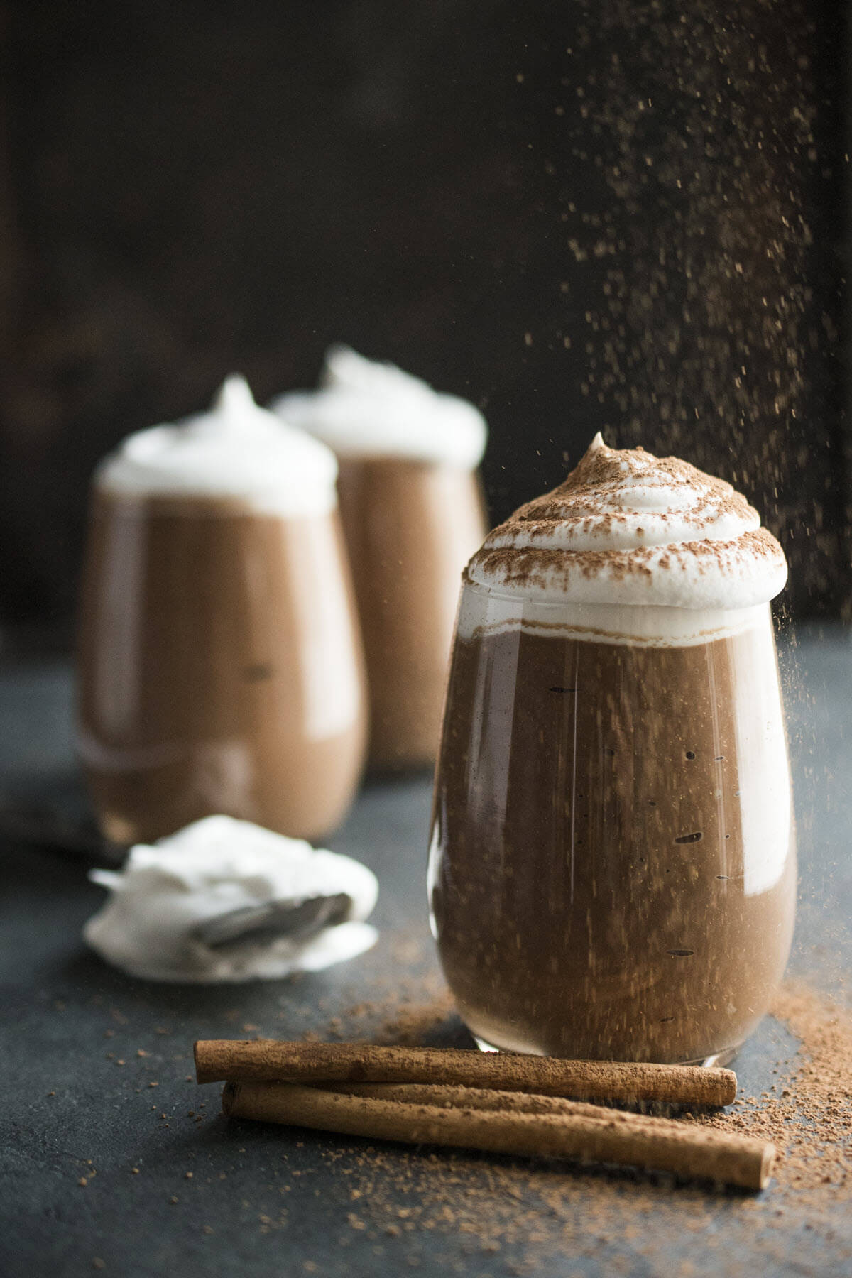 vegan chocolate mousse with whipped cream and chocolate sprinkles