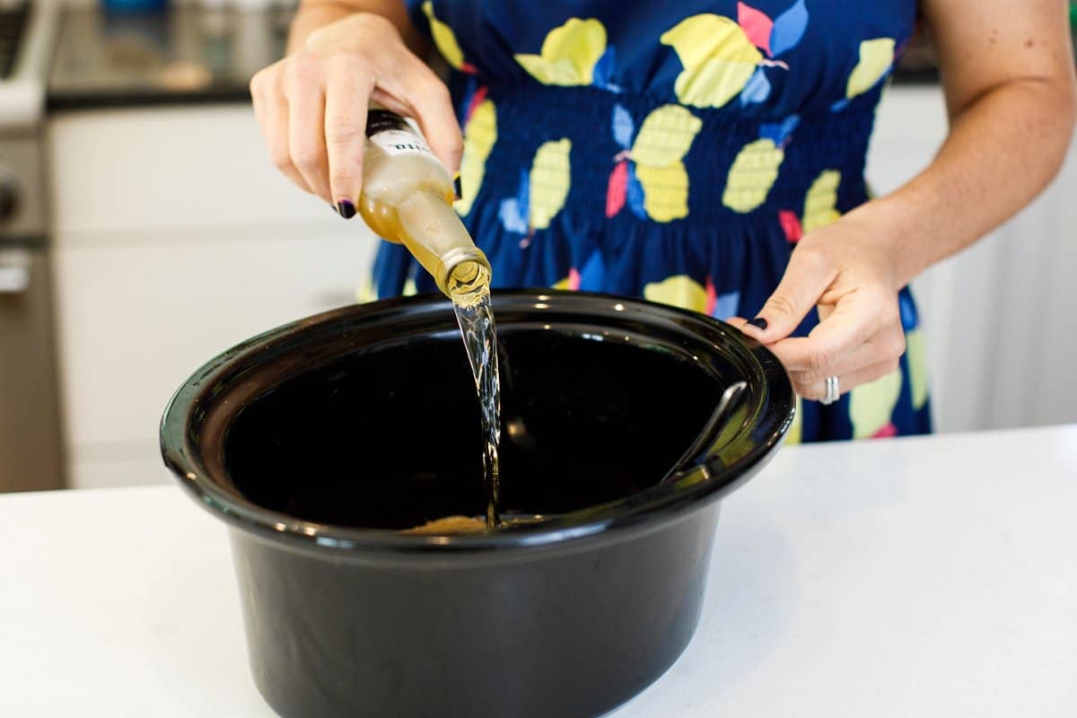 Liz Pouring in Beer for Slow Cooker BBQ Pulled Chicken
