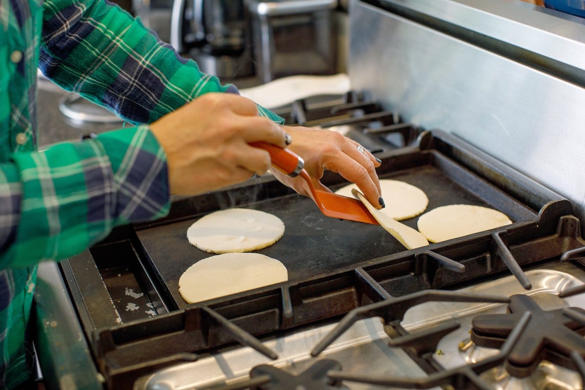 flipping corn tortillas 