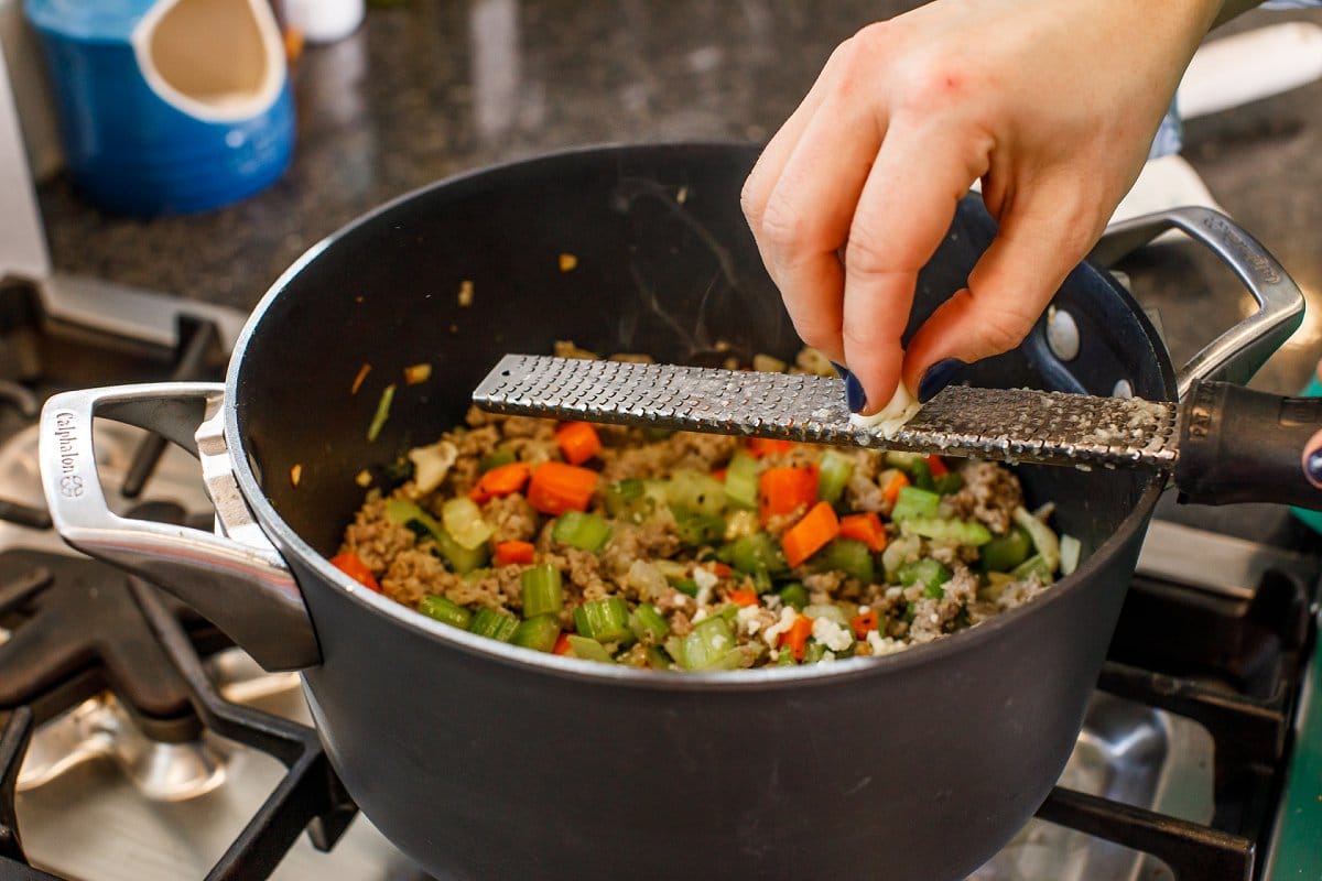 Garlic being grated for soup
