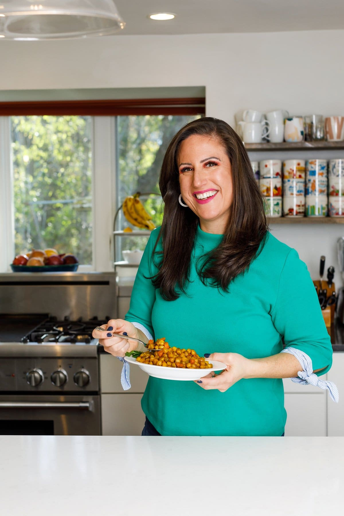Woman holding Jamaican Curry Chickpeas 