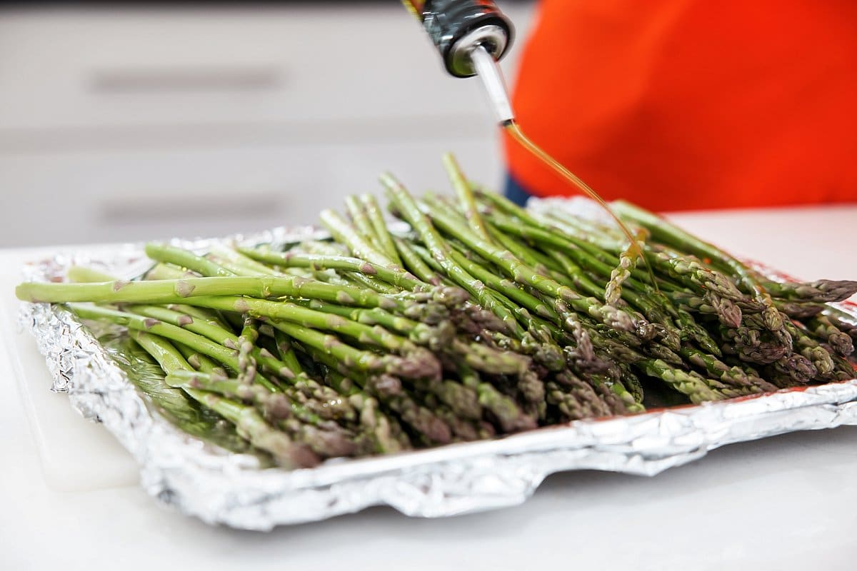drizzling olive oil over broiled asparagus