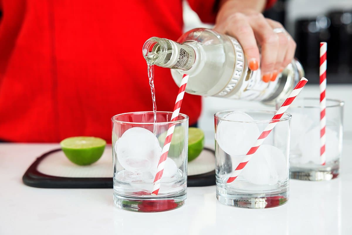 adding vodka to glasses