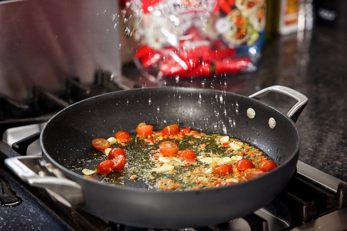 cooking tomatoes in a pan