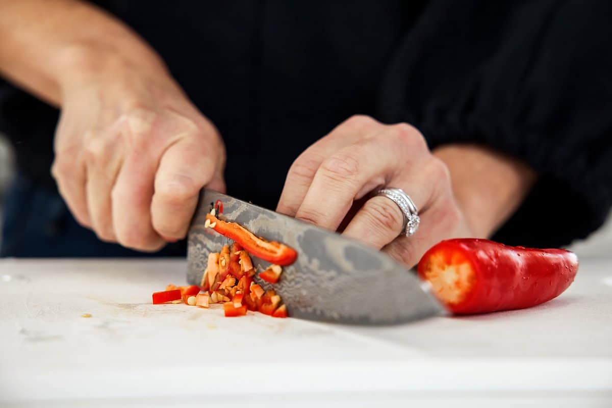 liz dicing red chili peppers