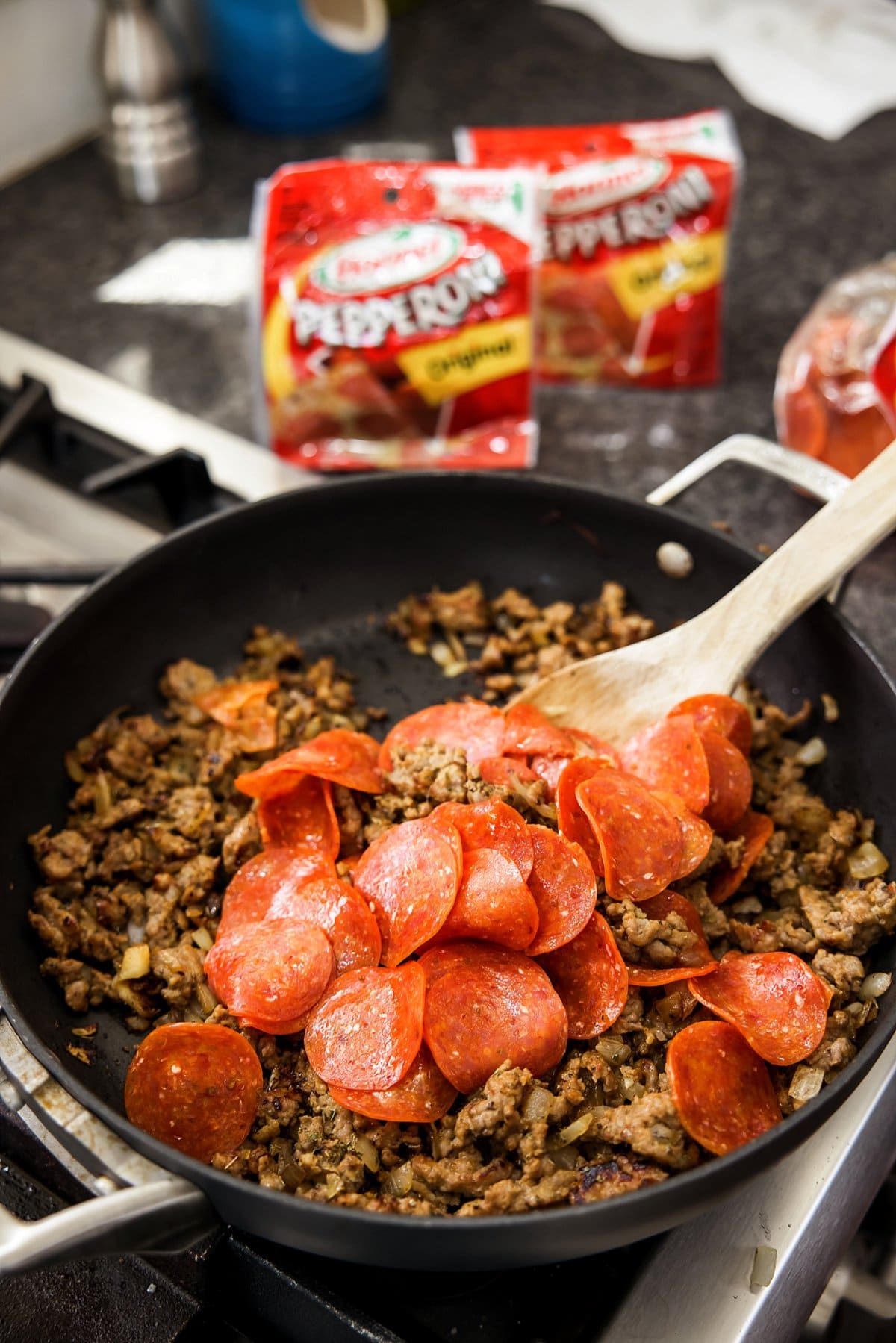 stirring pepperoni and sausage