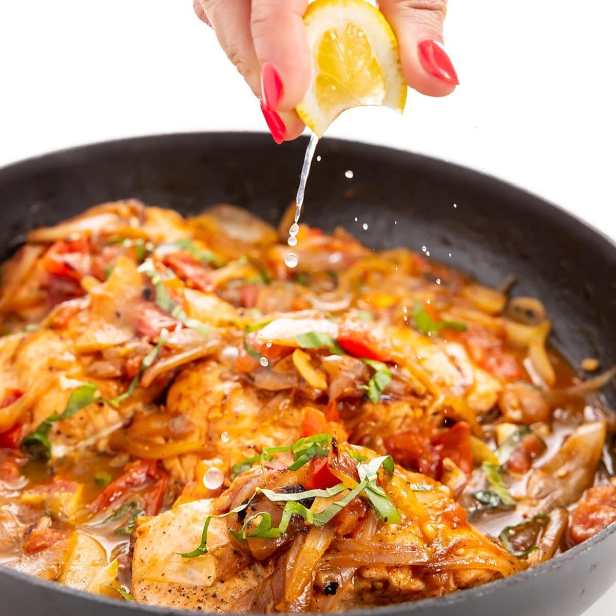 lemon juice being squeezed into pan