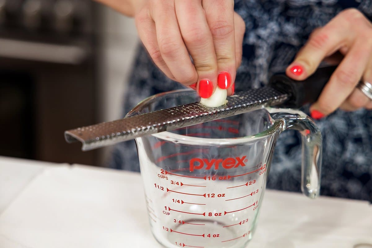grating garlic into a jar