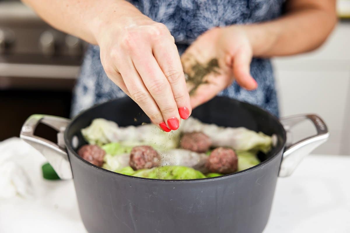 placing cabbage rolls in a pot