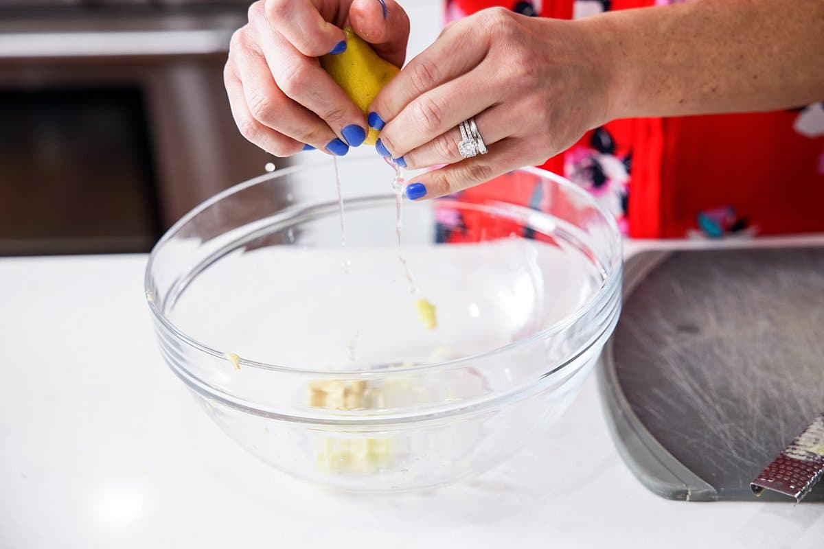 adding lemon to kale salad
