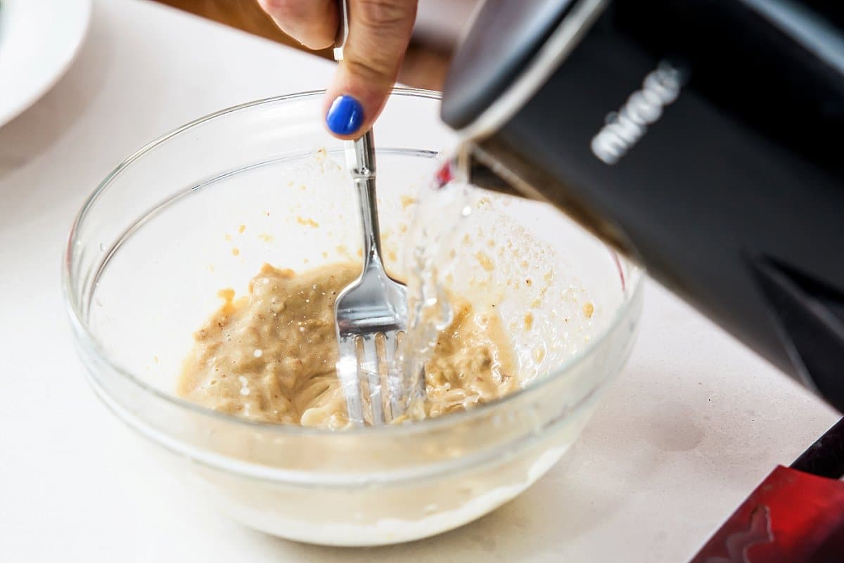 adding water to a chipotle sauce mix