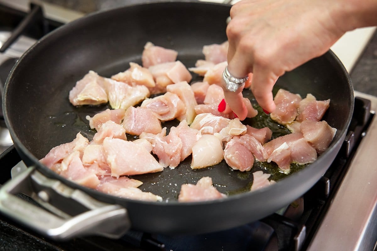 Sauteing chicken in a pan
