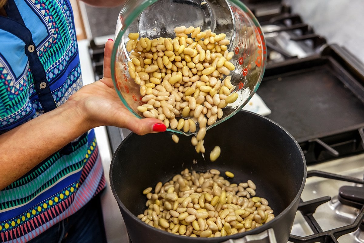 Adding soaked beans to pot