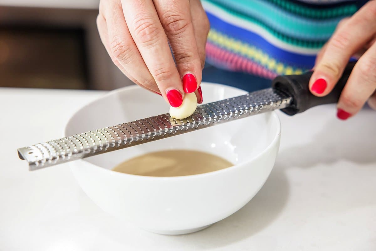 Grating garlic into sauce