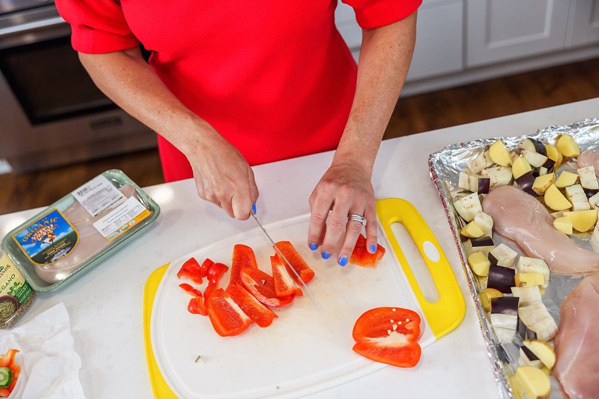 person cutting bell peppers