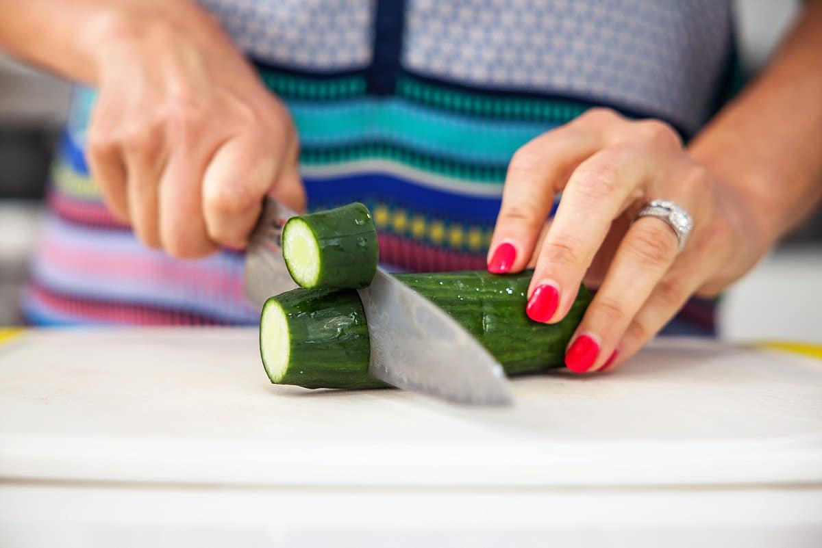 person cutting english cucmber
