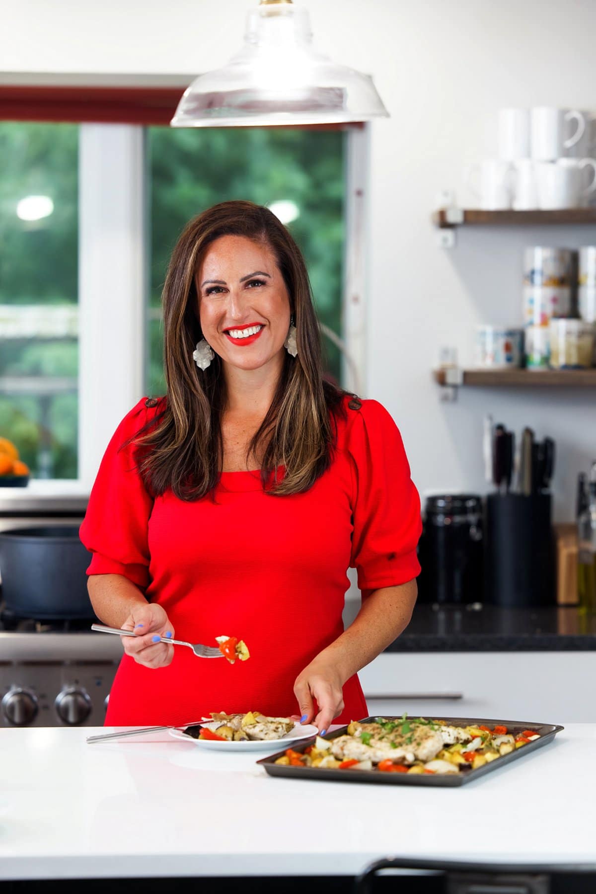 Liz enjoying sheet pan Greek chicken and vegetables.