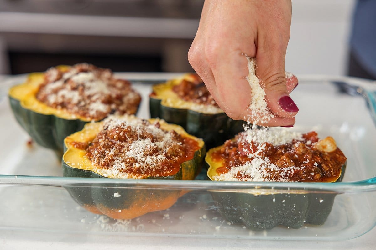 Baking sausage stuffed acorn squash.
