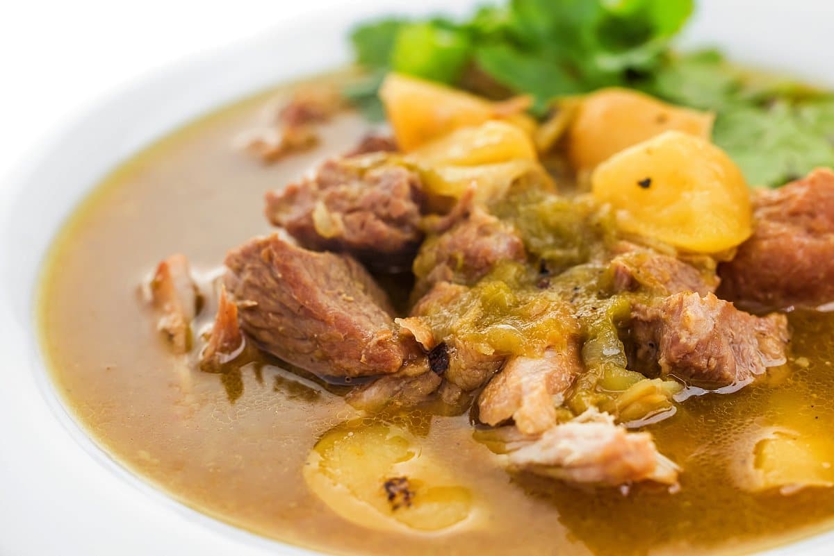 Green chile stew in a wide bowl.