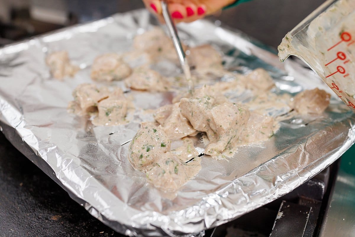 Marinated chicken put on prepared baking sheet.