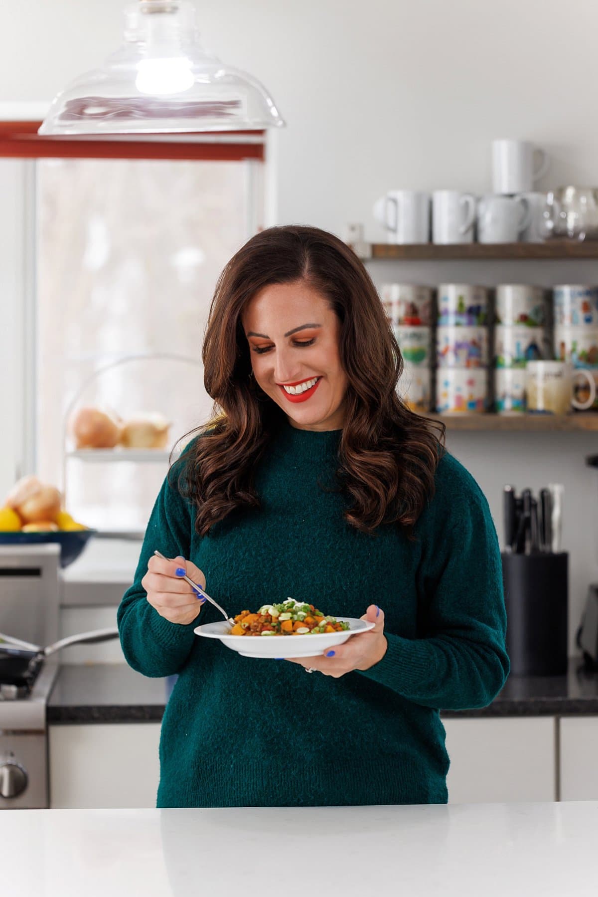 Liz eating curried lentils with sweet potatoes.