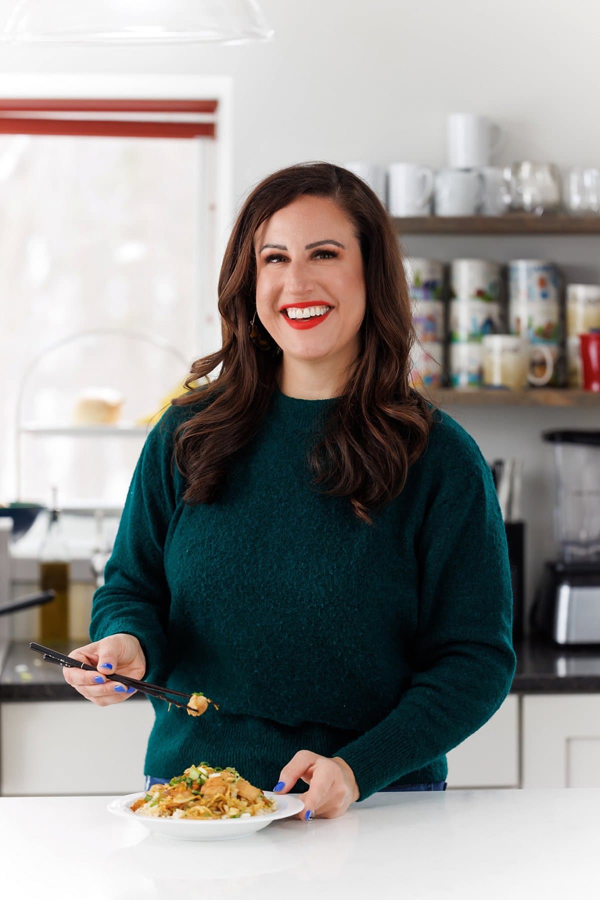Liz eating sesame chicken and Napa cabbage stir-fry.