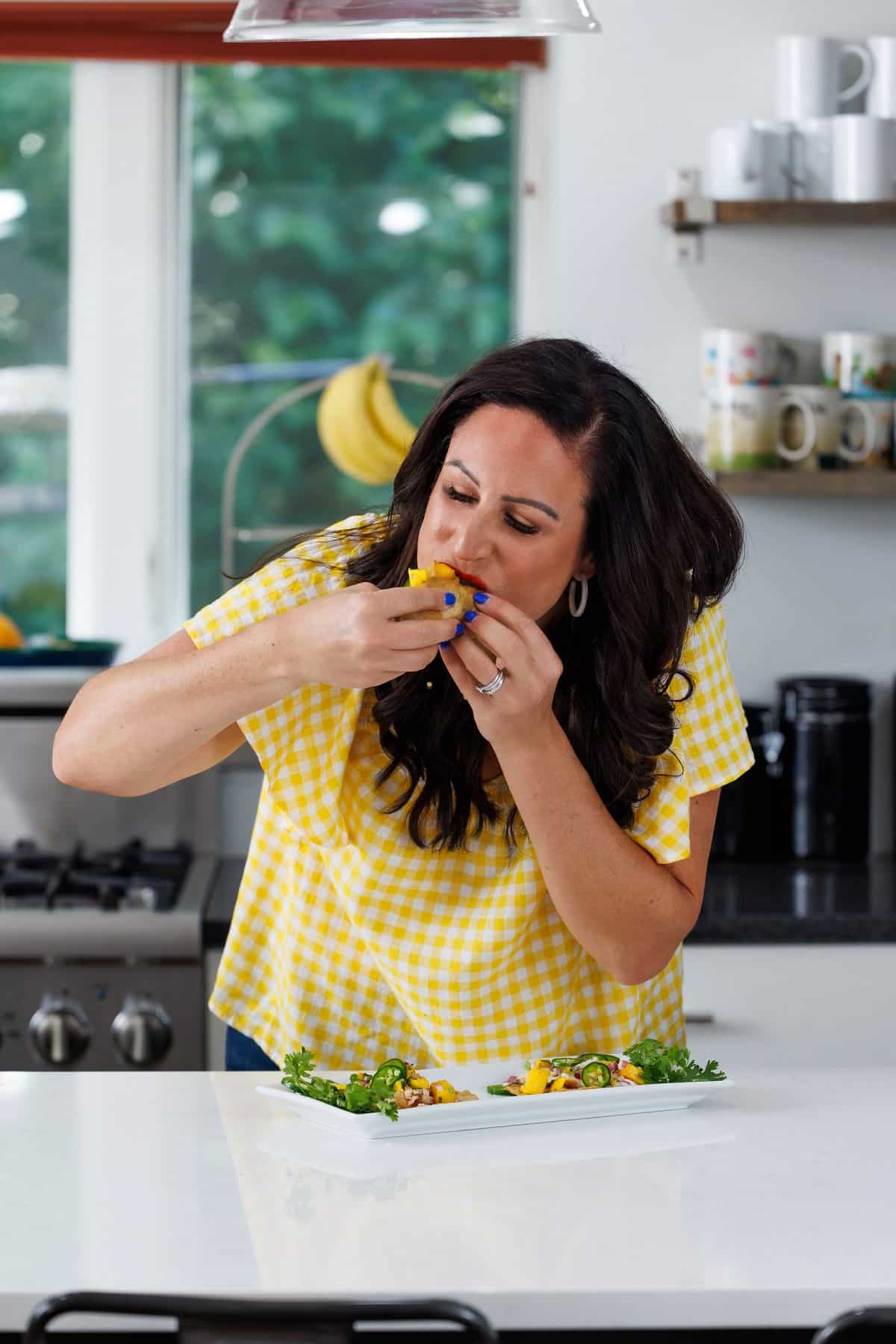 Liz eating fish tacos with mango salsa.