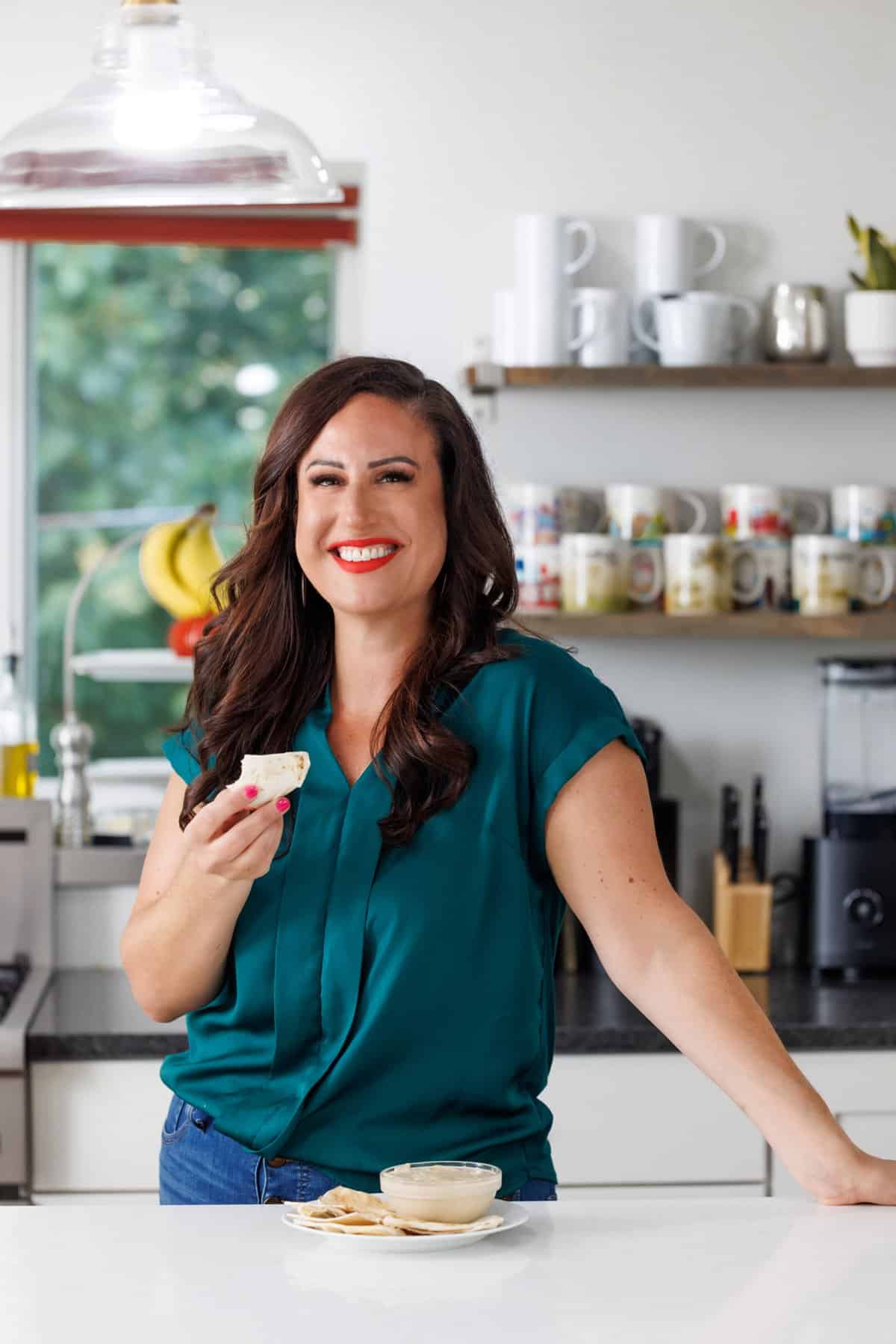 Liz eating tahini sauce with pita bread.