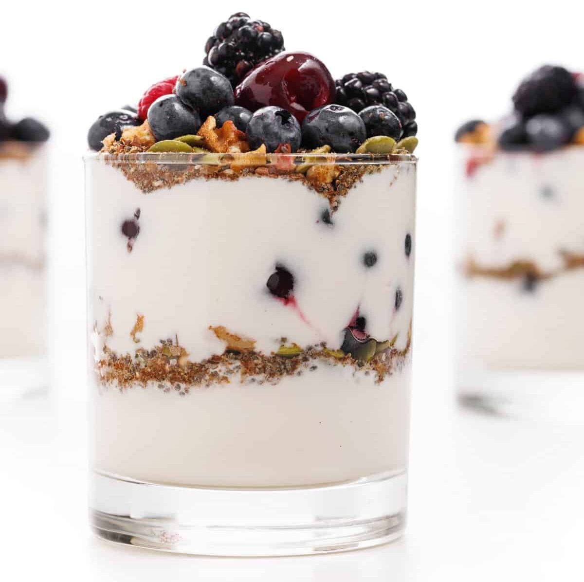 Fruit and yogurt protein parfait in a glass cup.