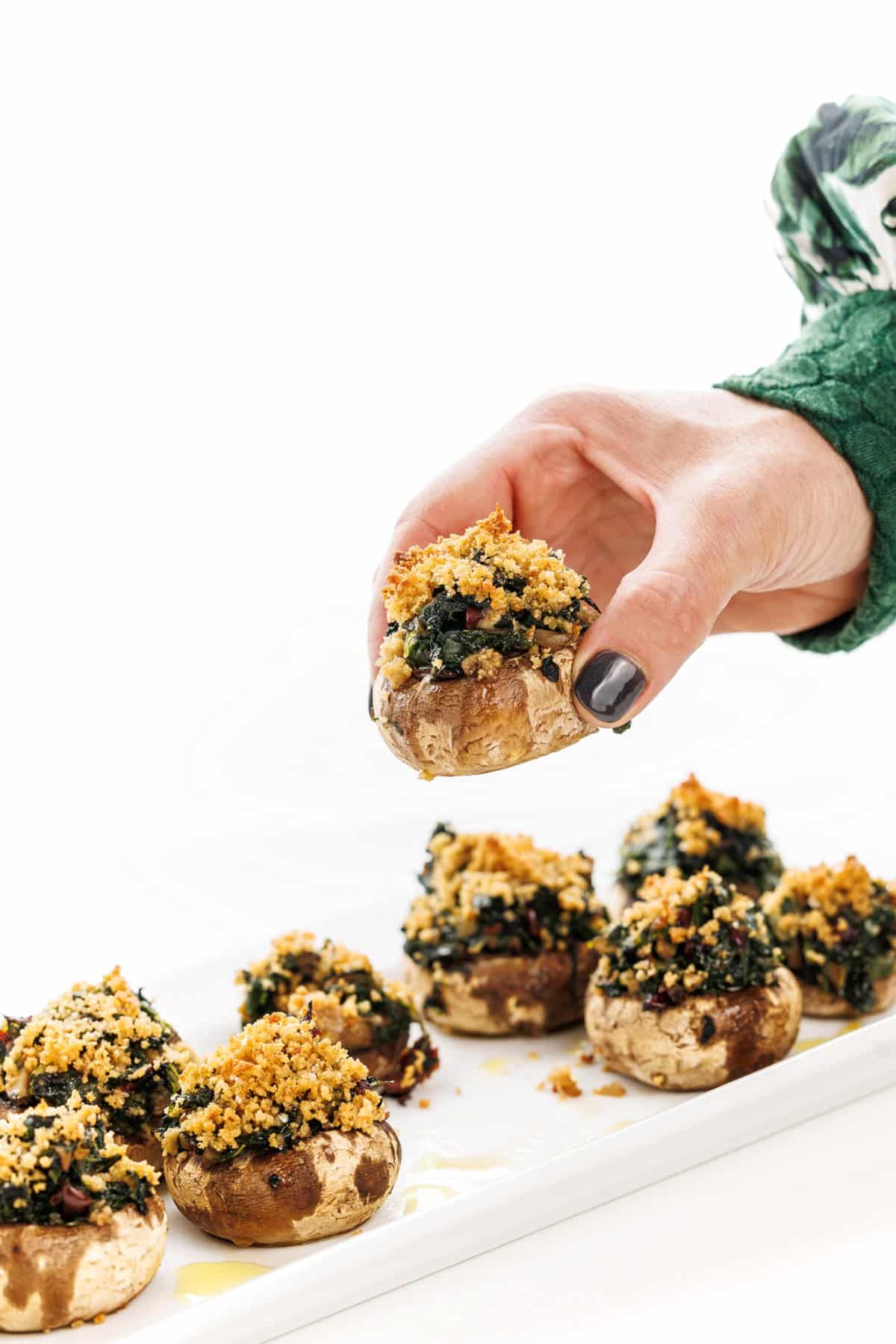 Grabbing a vegan stuffed mushroom.