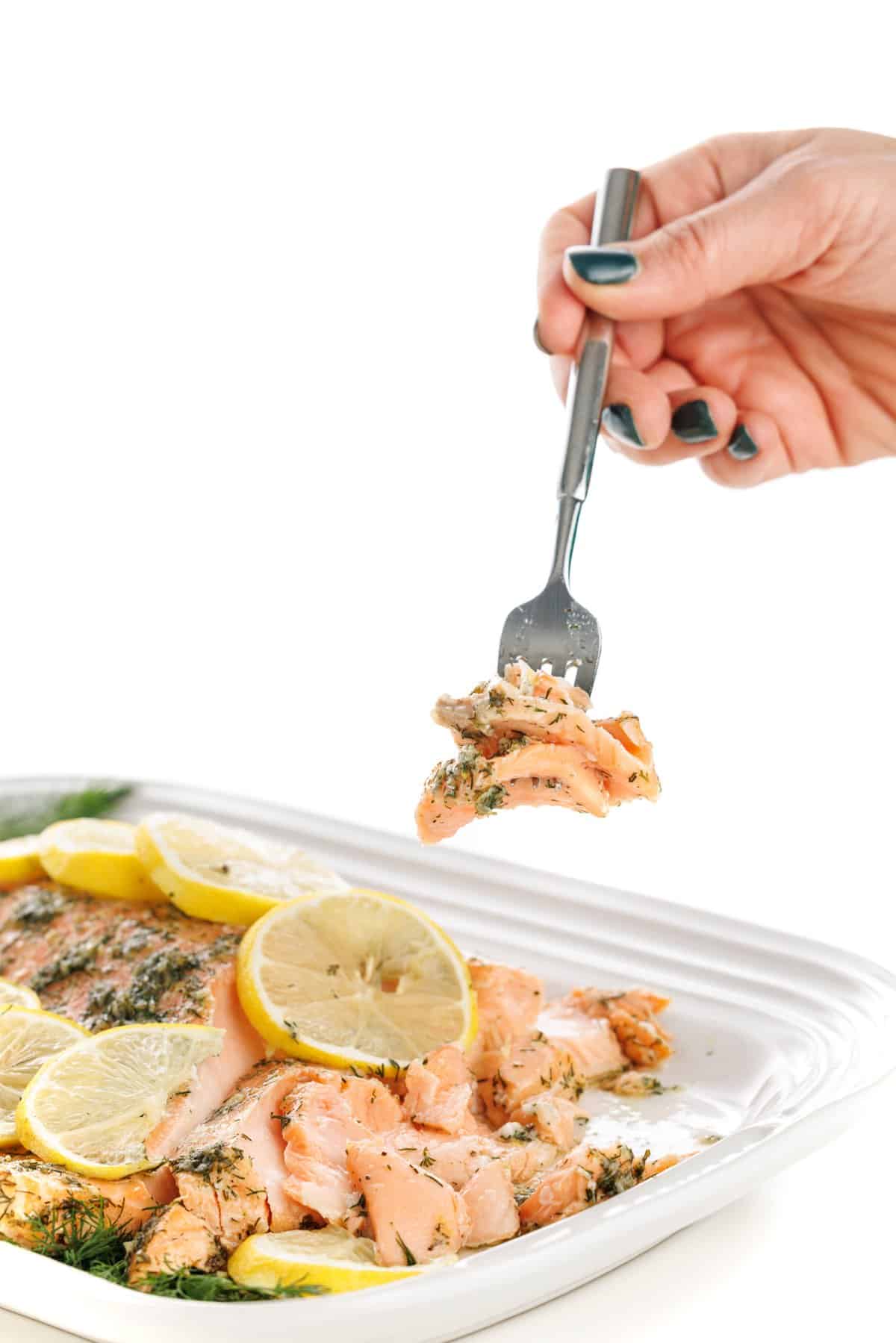 Forkful of garlic and dill roasted salmon.