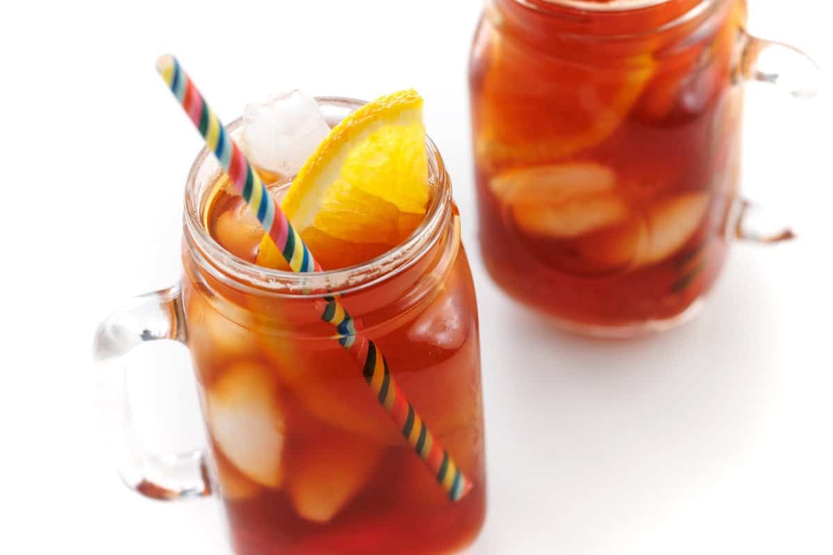 Orange ginger tea iced with a lemon wedge.