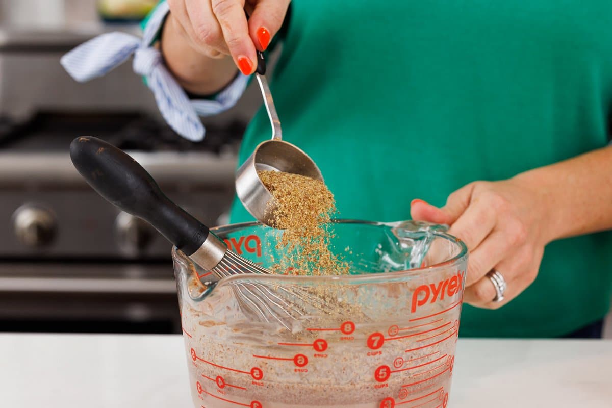 Adding flax seed meal to milk mixture.