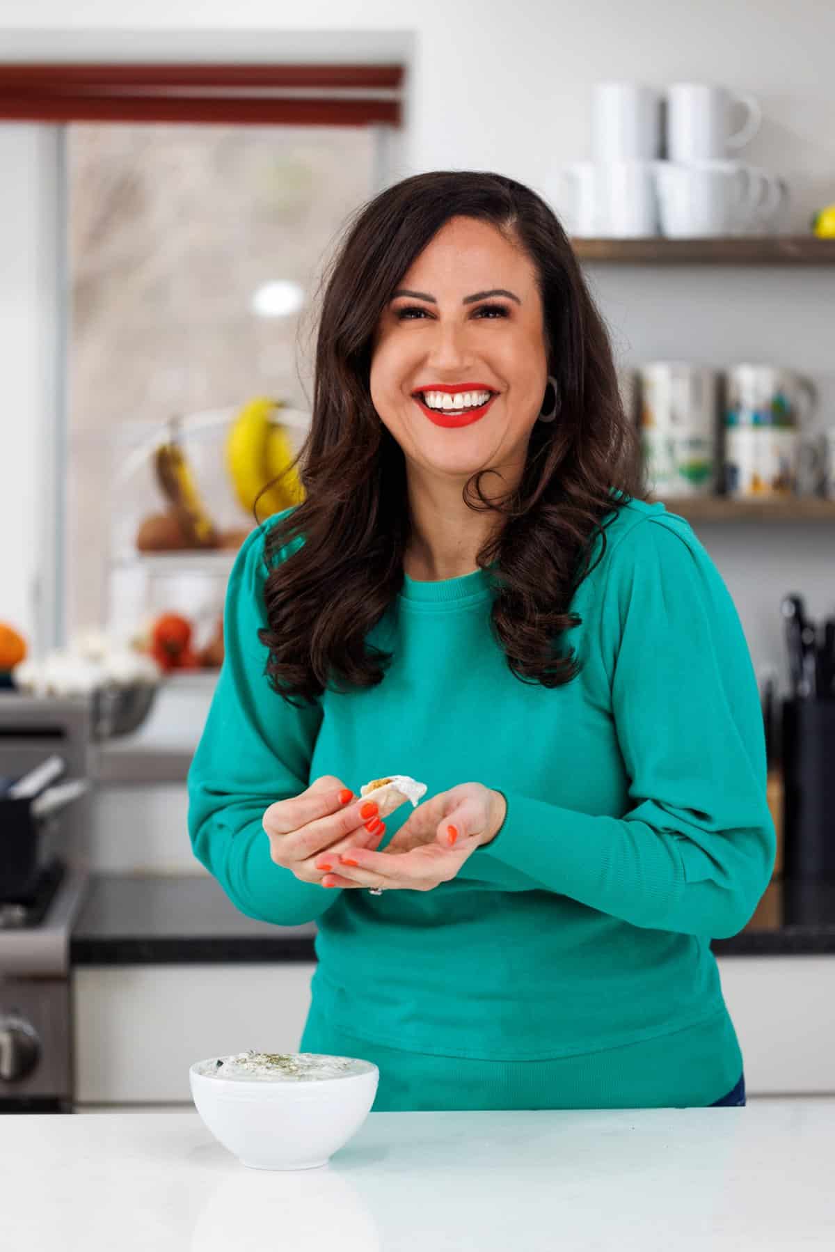 Liz eating cucumber laban Lebanese yogurt sauce.