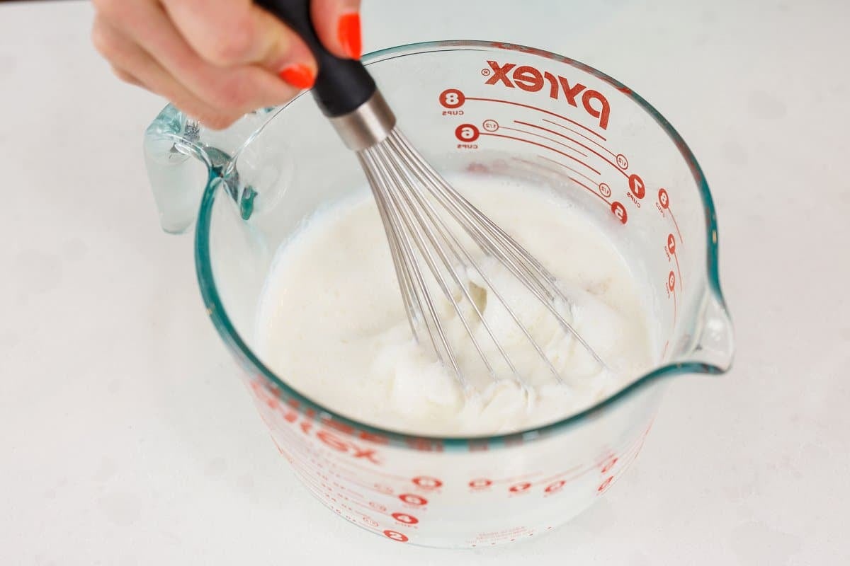 Whisking milk and yogurt mixture.