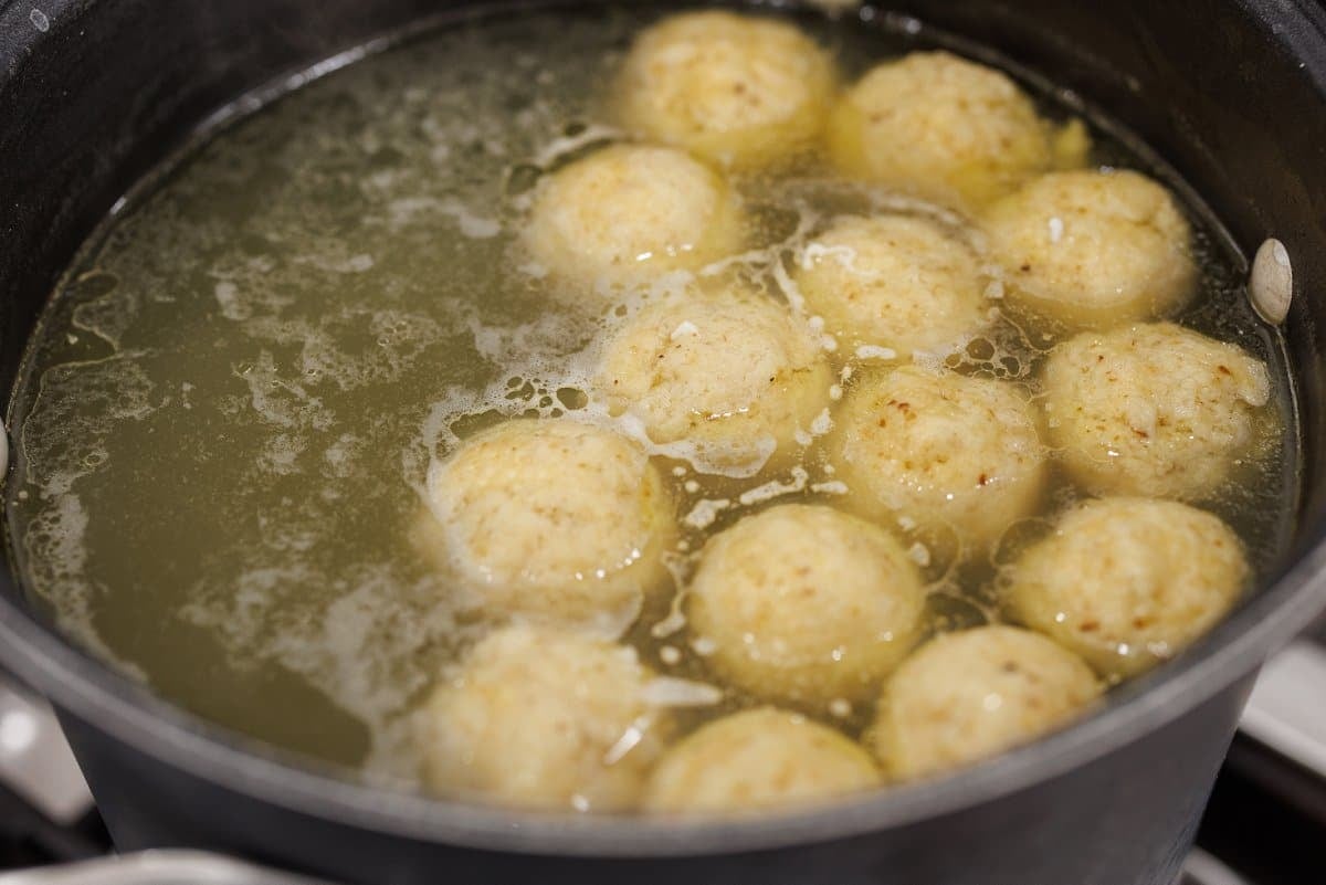 Cooked matzo balls in chicken stock.