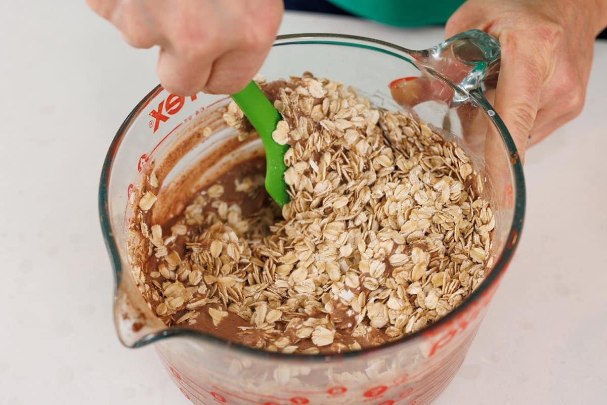 Mixing overnight oats ingredients together in large measuring cup.