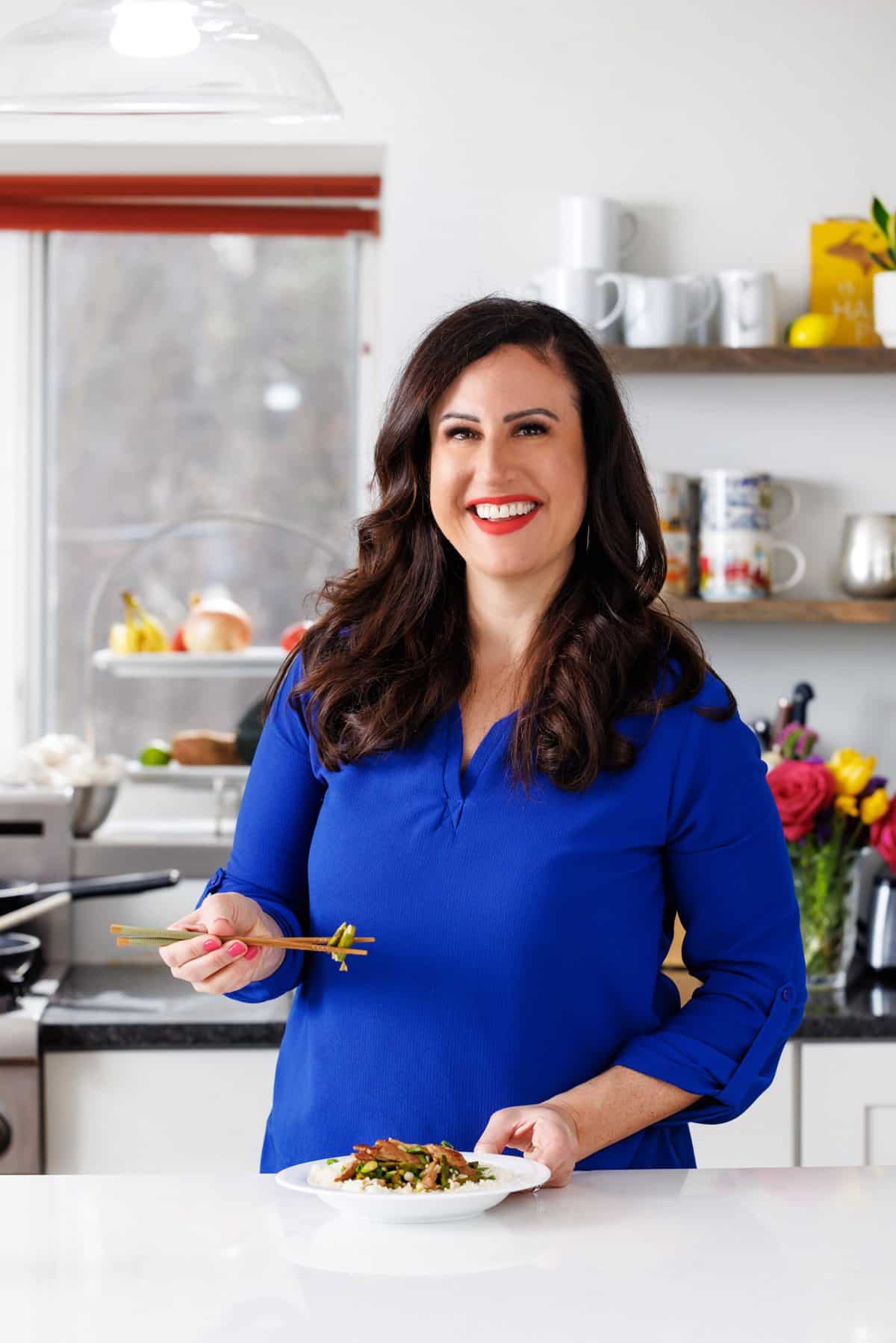 Liz eating pork and asparagus stir fry.