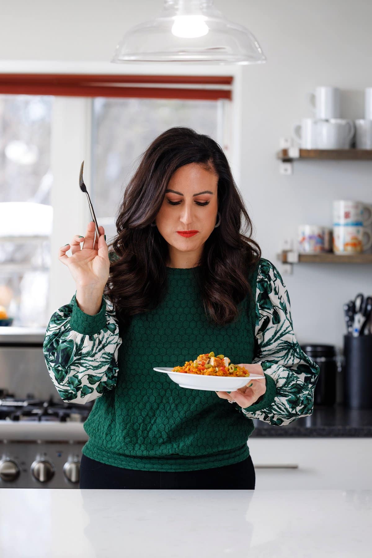 Liz eating slow cooker arroz con pollo.