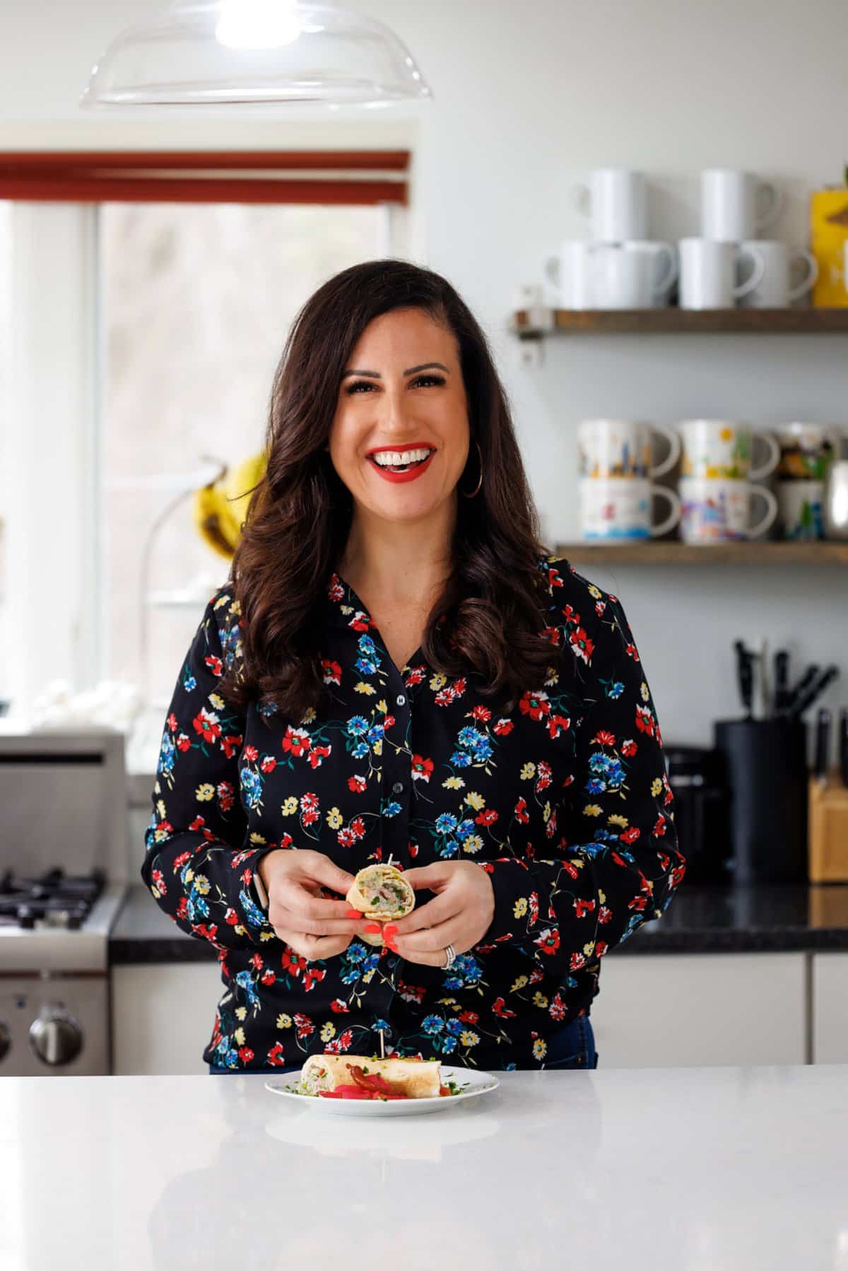 Liz eating vegetarian middle eastern pita wrap.