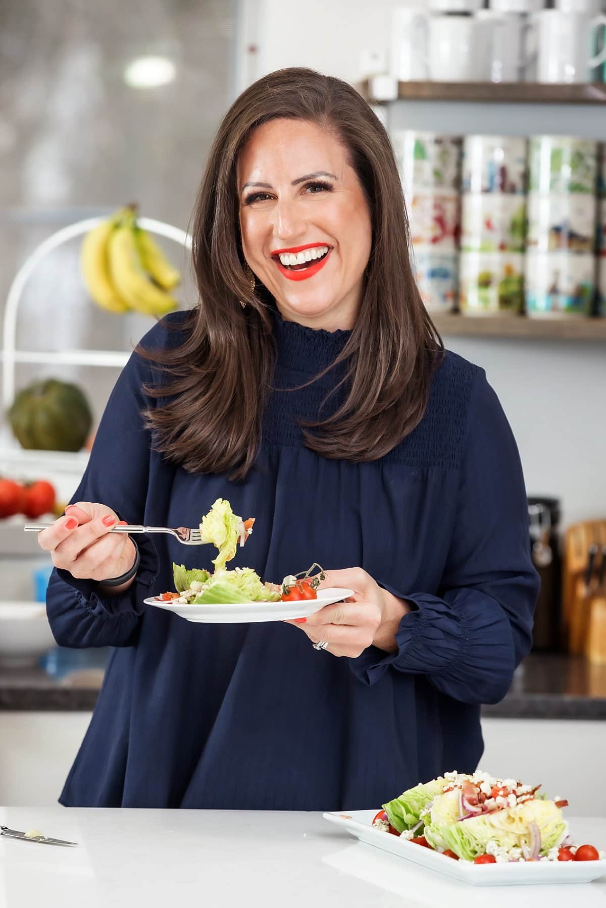 Liz eating wedge salad with bacon and blue cheese vinaigrette.