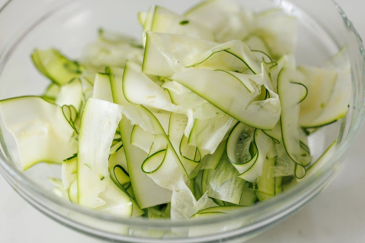 Bowl full of cucumber and zucchini ribbons.