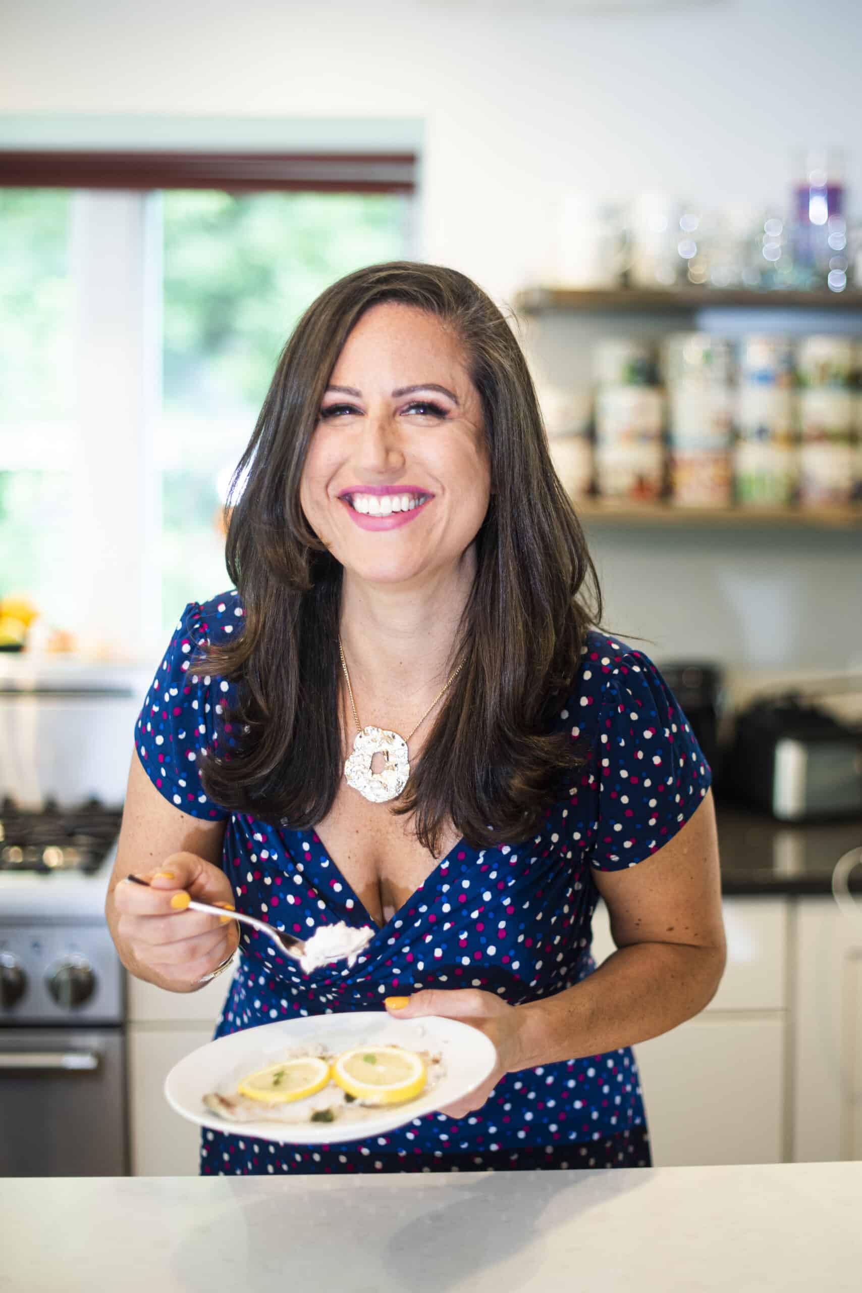 Liz eating lemon butter baked white fish.