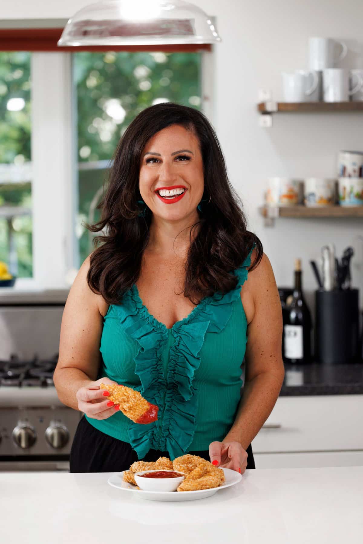 Liz eating oven-fried chicken tenders with panko.