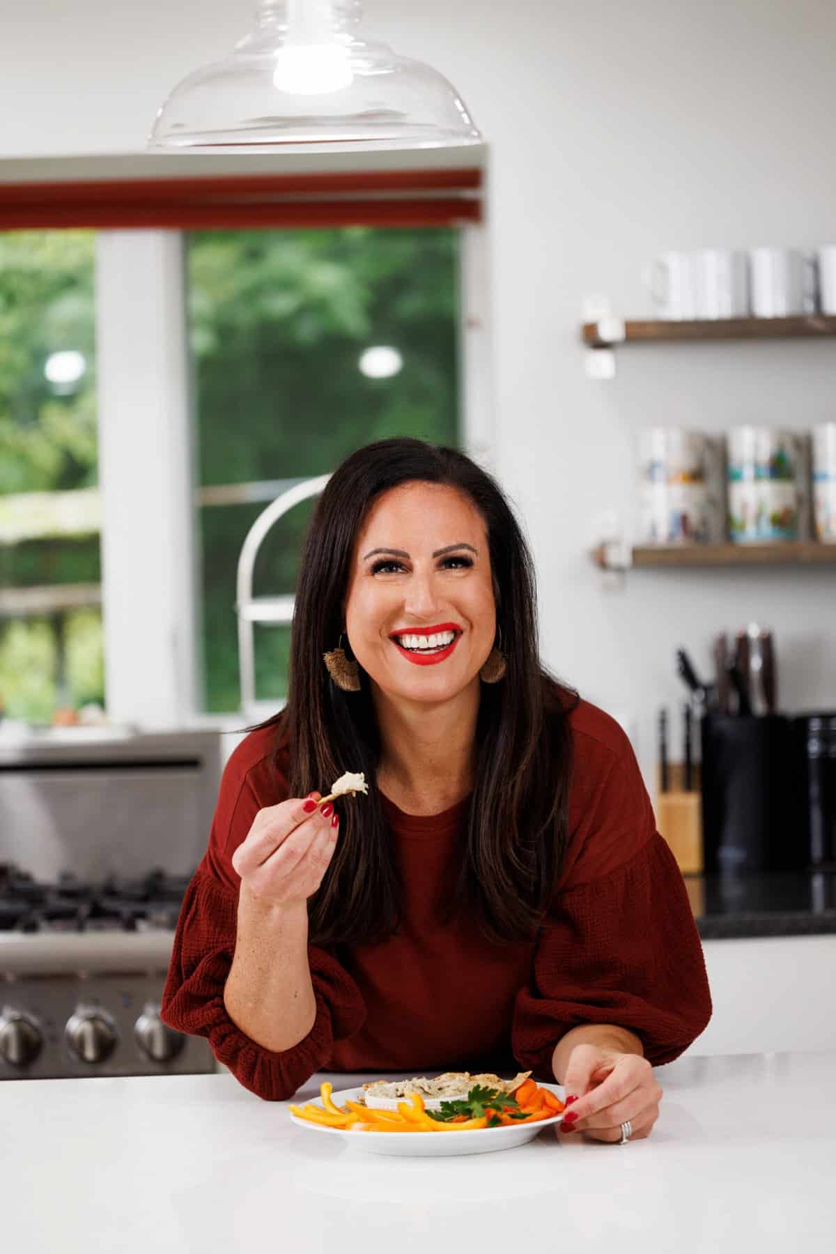 Liz eating white bean and roasted eggplant dip.