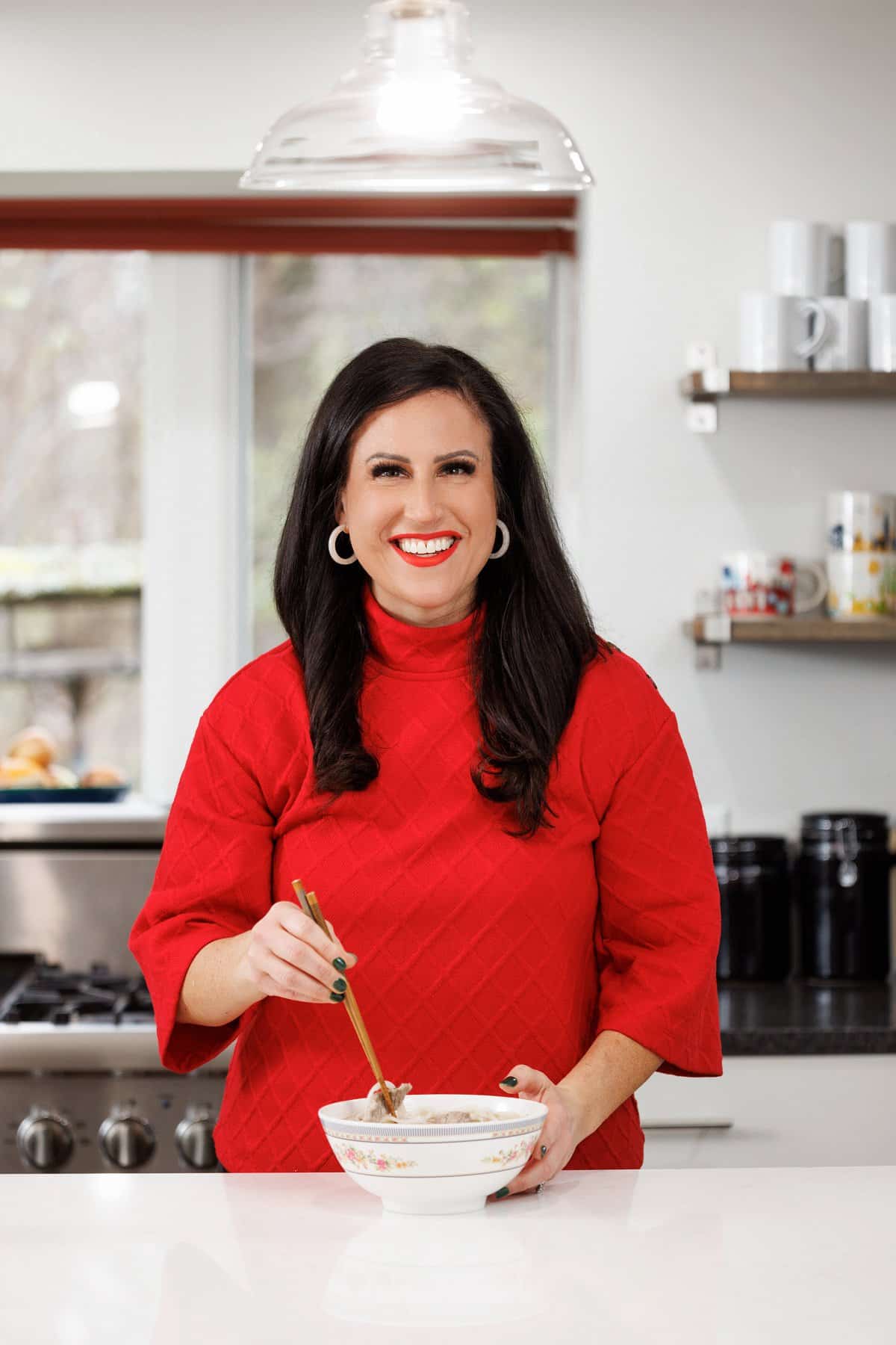 Liz eating beef pho bone broth with noodles.