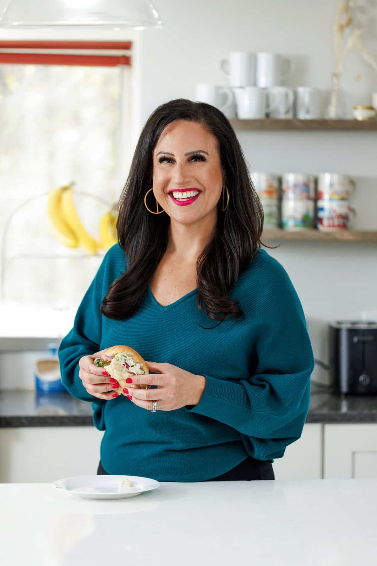 Liz eating chicken salad sliders.