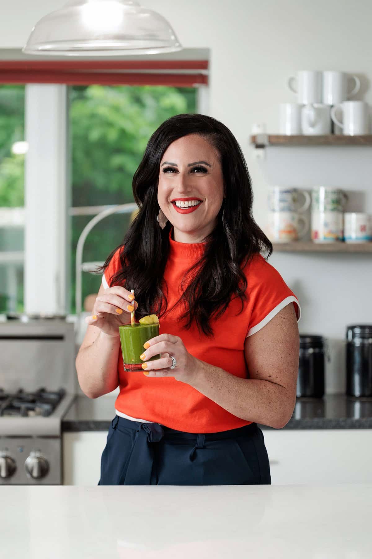 Liz drinking a tropical green smoothie.